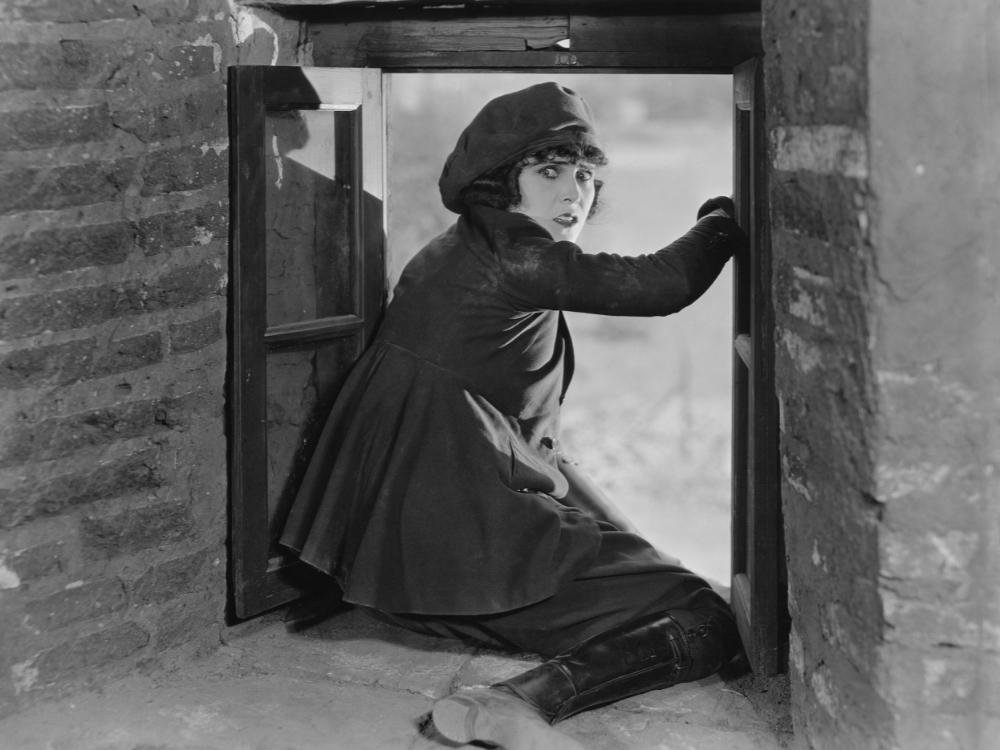 Woman climbing out a window.