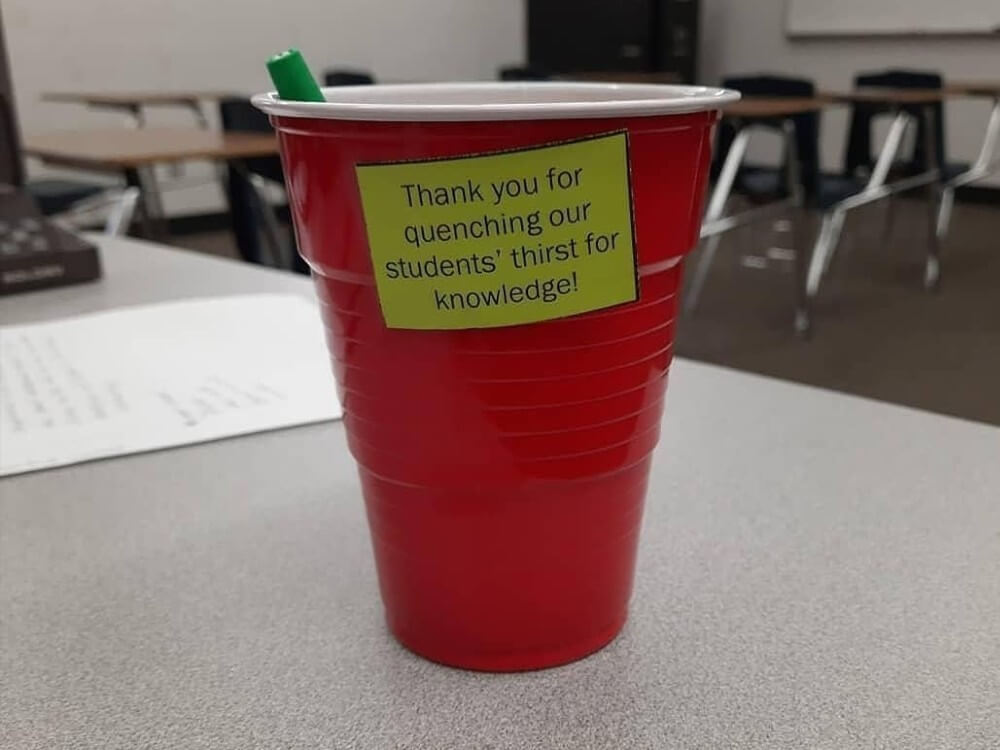 Red plastic Solo cup with a note attached to it that reads - Thank you for quenching our students' thirst for knowledge!