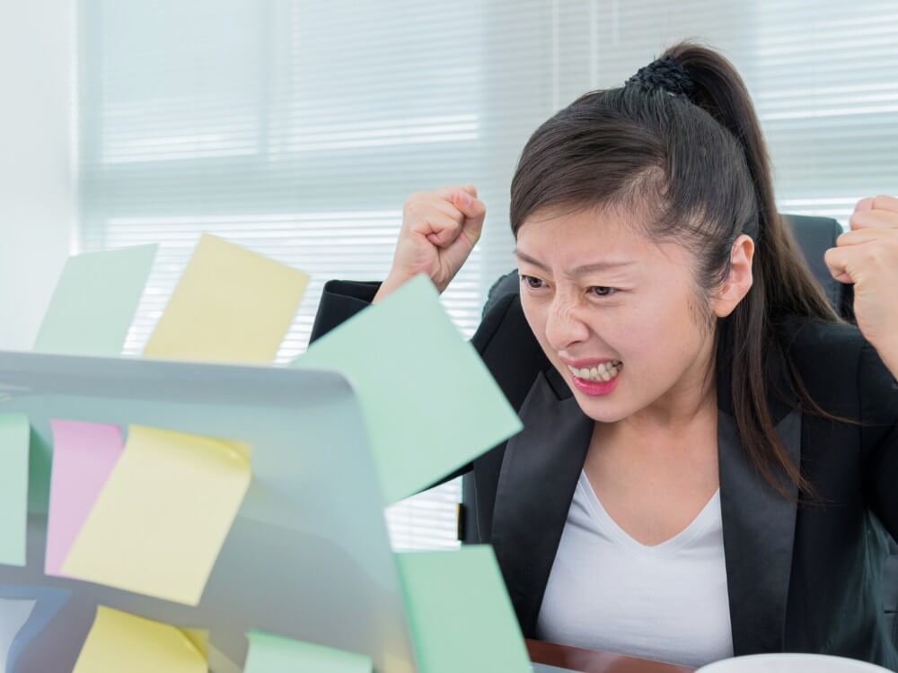 Woman angrily looking at her computer.
