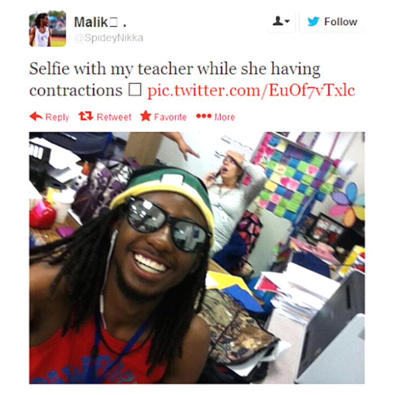Student taking a selfie with his pregnant teacher who is in labor.